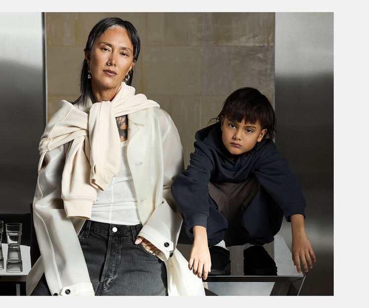 A mother and child next to each other, looking directly into the camera.