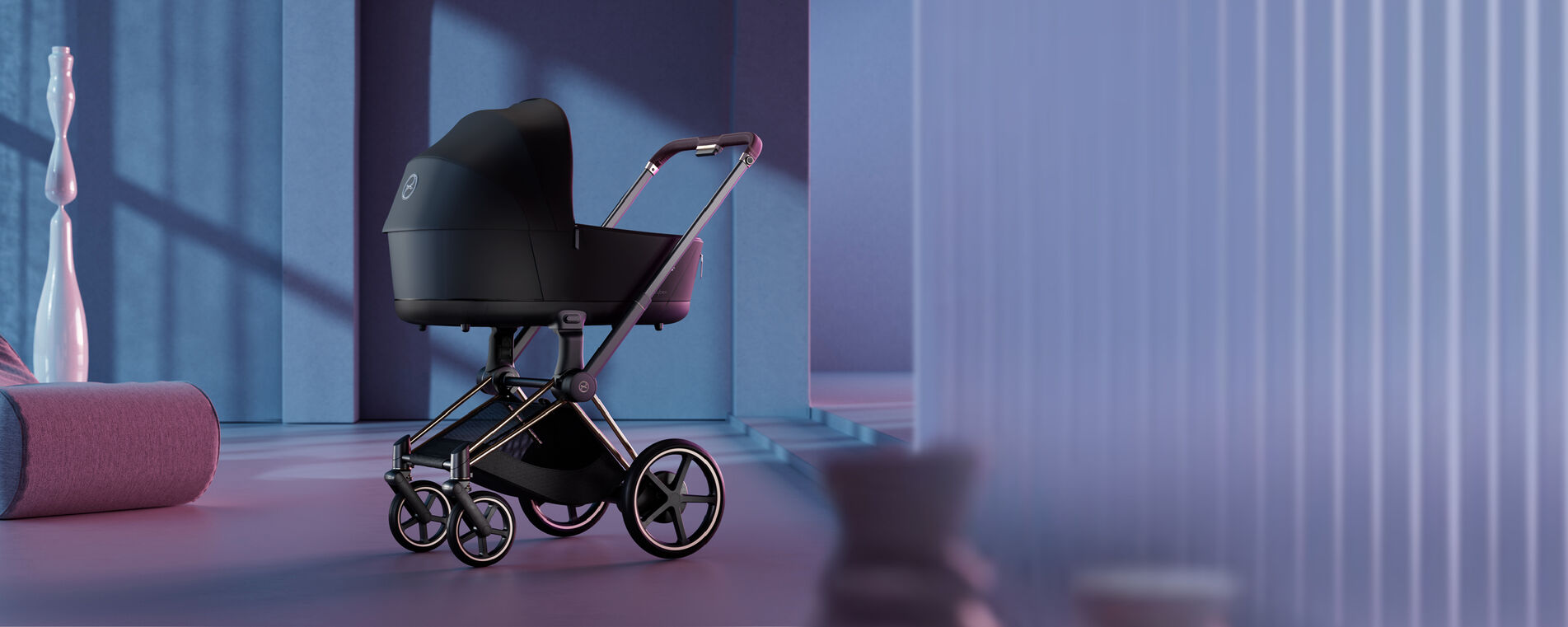 Priam stroller on wooden surface, a wooden chair behind it as well as two black, fake birds sitting next to it.