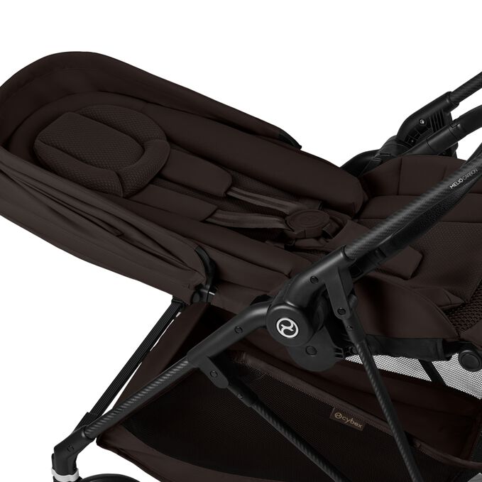 An image of the CYBEX Gold Melio Carbon Stroller, highlighting the Newborn Nest feature.