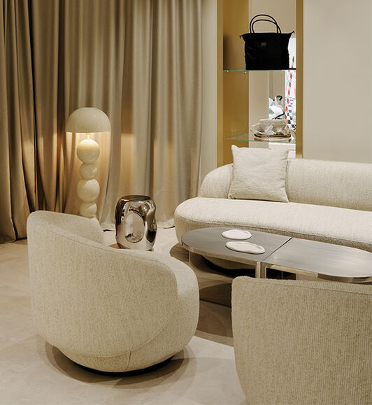 Two armchairs and a couch inside the Flagship Store Berlin.