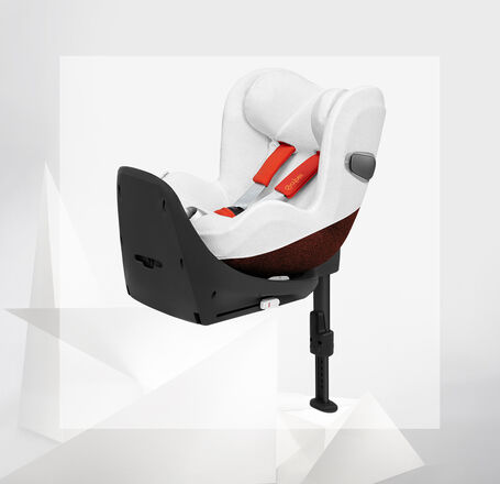 Sirona Z2 car seat in white with red harness on a modern background.