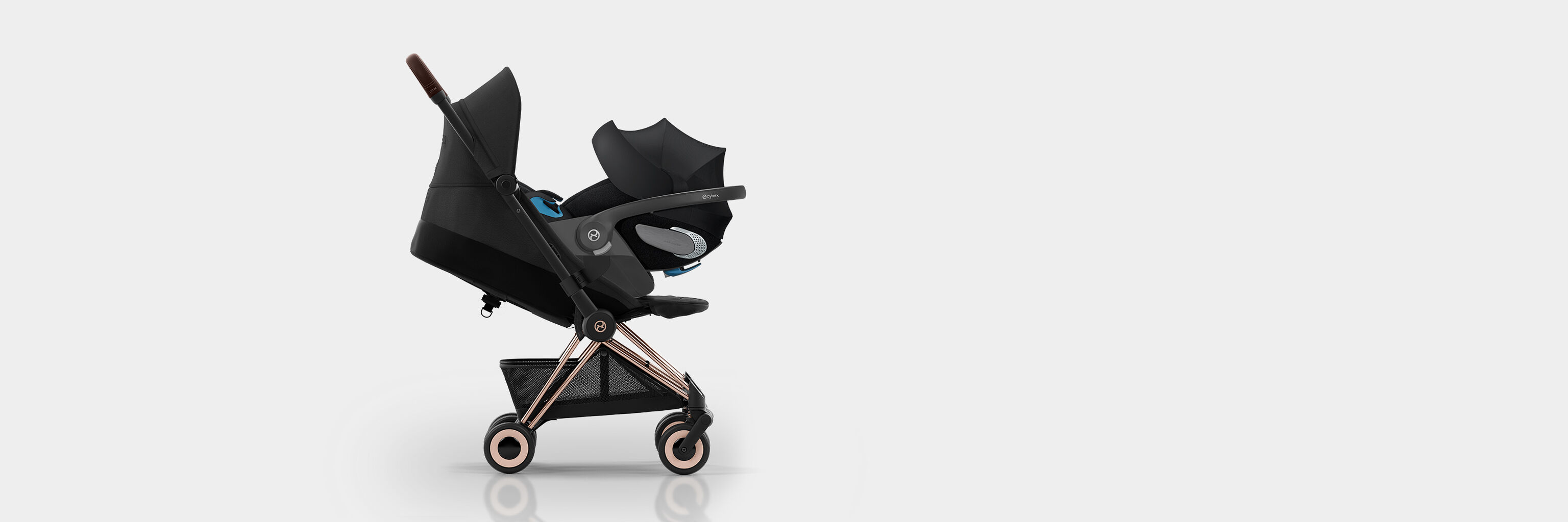 Side view of Coya compact travel stroller on a white background.