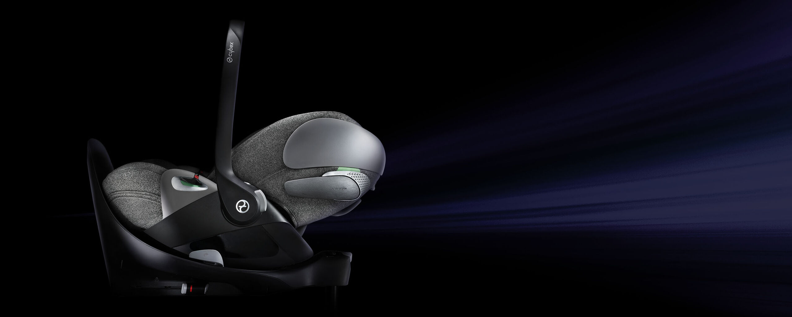 A grey Cybex car seat on a dark background.