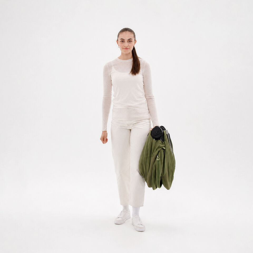 A woman carrying a folded up Talos S Lux.