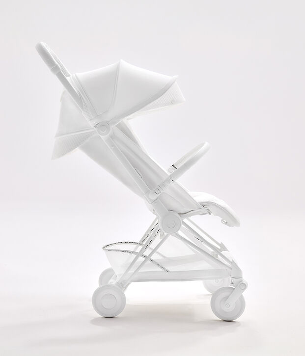 Sideview of a Coya Urban Mobility Travel Buggy in white.