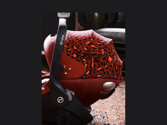 CYBEX Rockstar infant car seat with red leopard print on a carpet.