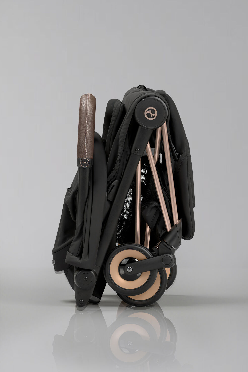 Side view of a folded up Coya stroller.