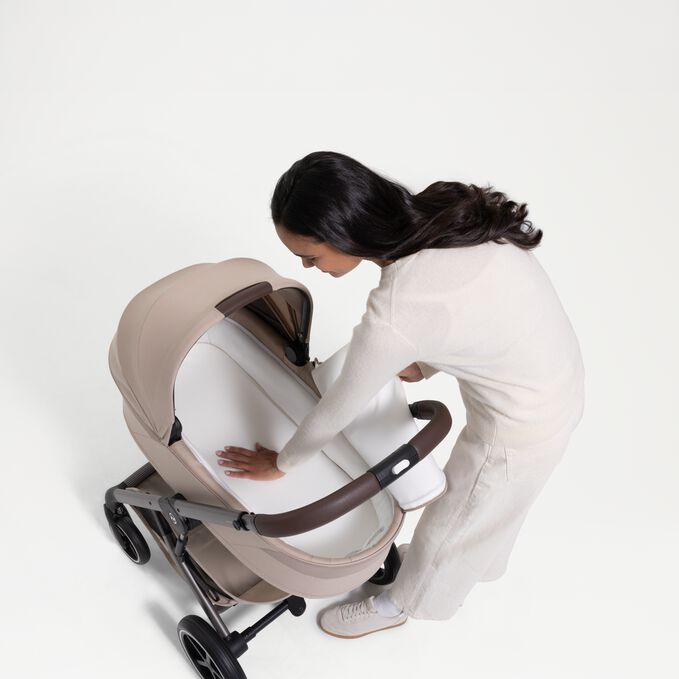 An image of the CYBEX Gold Balios Fold Cot Stroller, highlighting the Spacious Cot With Soft Foam Cushion feature.