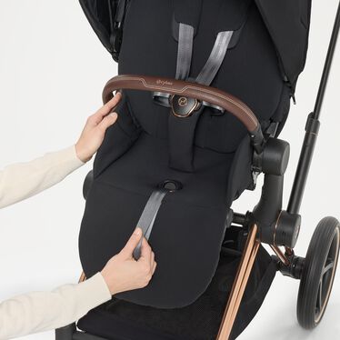 An image of the CYBEX Platinum Priam Stroller, highlighting the One-Pull Harness feature.