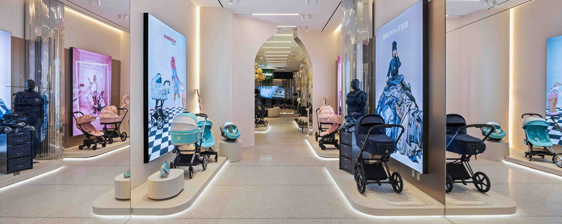 A hallway with different CYBEX collections. Two mirrors on the left and right reflecting the store.
