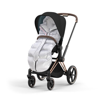 Stroller with black canopy and silver footmuff on a white background.