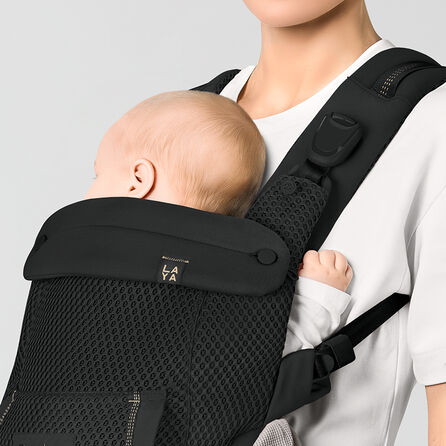 Close up of a baby in a Laya baby carrier with the cushioned neck support making it comfortable for the child.