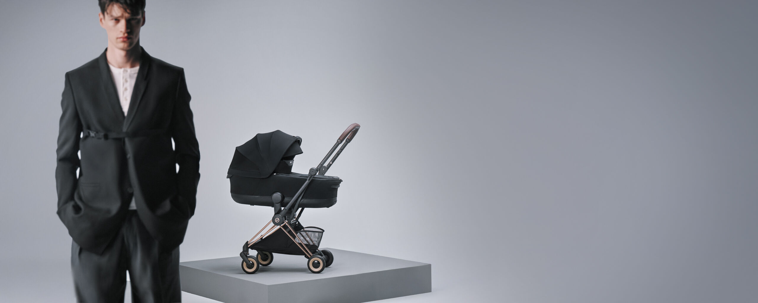 A man standing before a Coya buggy with a seat pack attached. The buggy is in focus, the man slightly blurry.