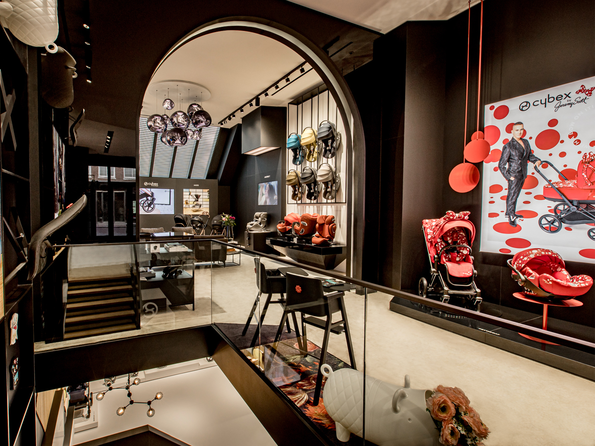 Interior of CYBEX Flagship Store Amsterdam featuring modern strollers and stylish decor.