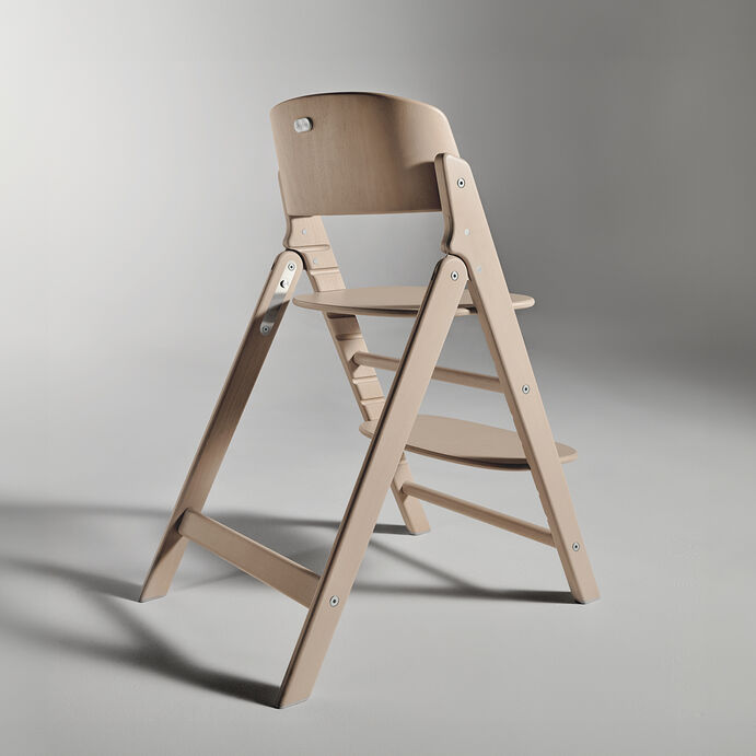 Side view of a Click and Fold high chair made of light wood.