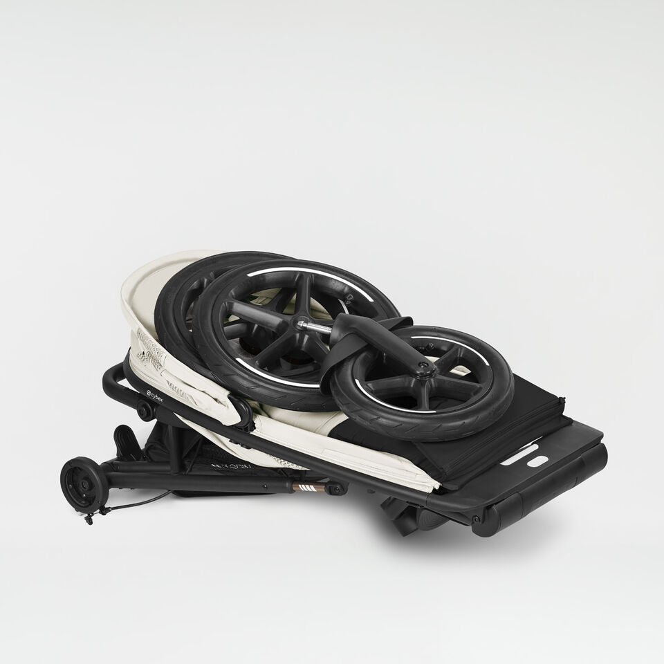 Product shot of a folded Avi Spin stroller.