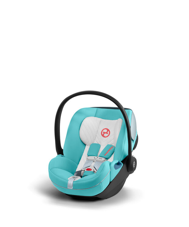 by Jeremy Scott Wings baby car seat in turquoise and white with a black handle.