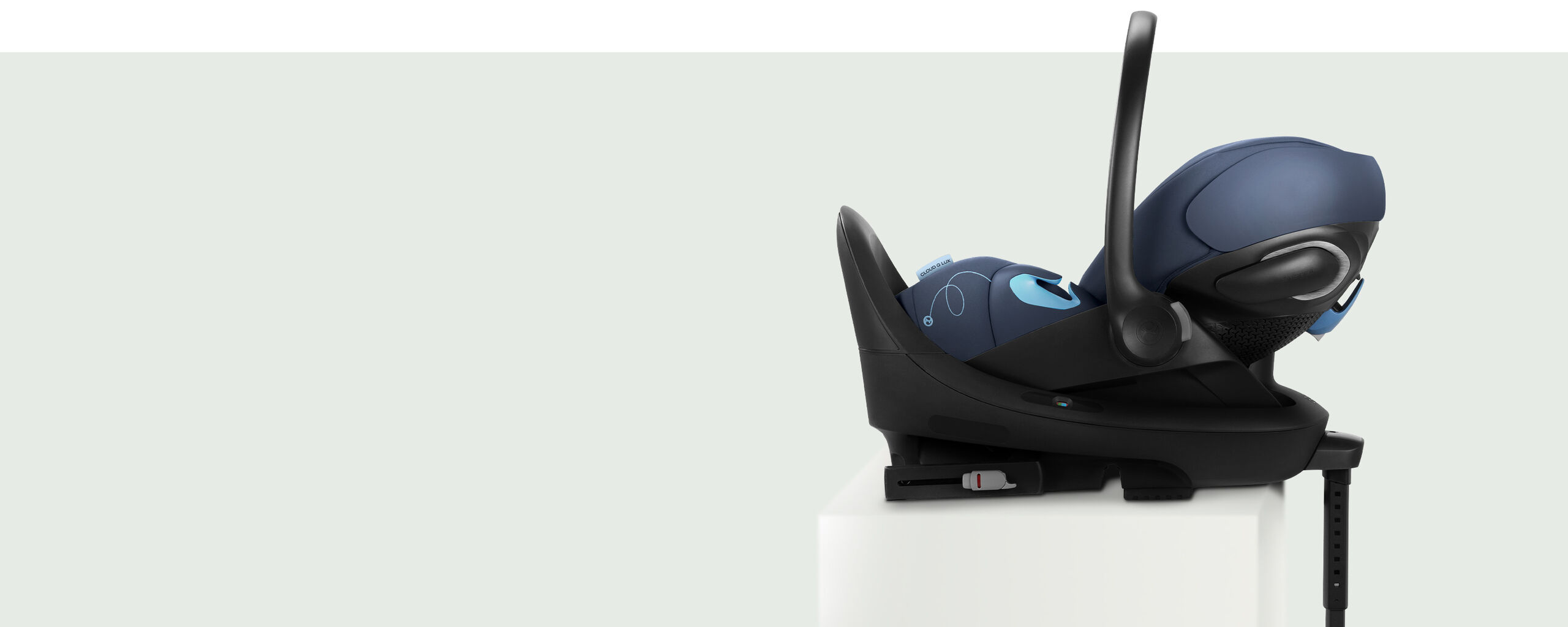 Side view of the Cloud G reclining infant car seat on a white pedestal.