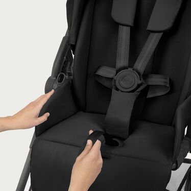 An image of the CYBEX Gold Melio Carbon Stroller, highlighting the One-pull Harness feature.