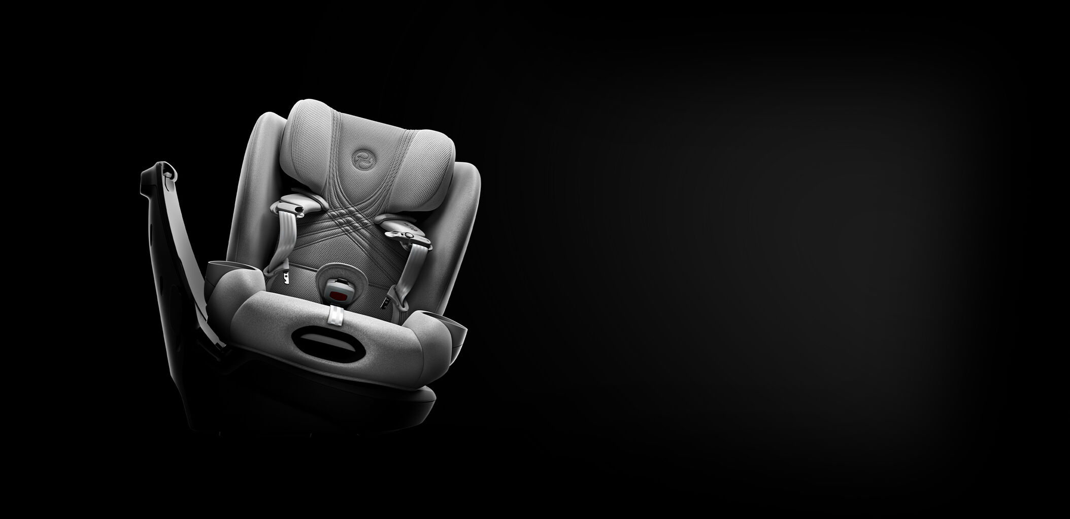 A Callisto T 360 car seat in a base turned to the side, with a focus on the open harness buckles.