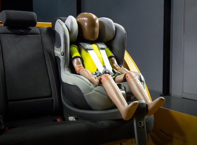 A test dummy sitting inside a CYBEX car seat in a test vehicle.