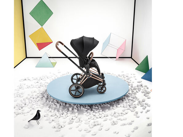 A CYBEX Platinum stroller with a seat pack attached.