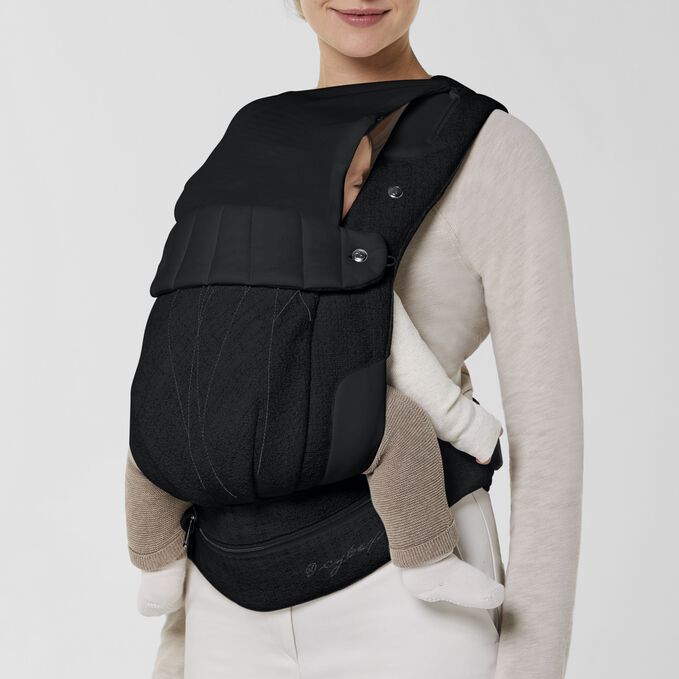 An image of the CYBEX Platinum Coya Carrier Bouclé Baby Carrier, highlighting the Integrated Head Cover feature.