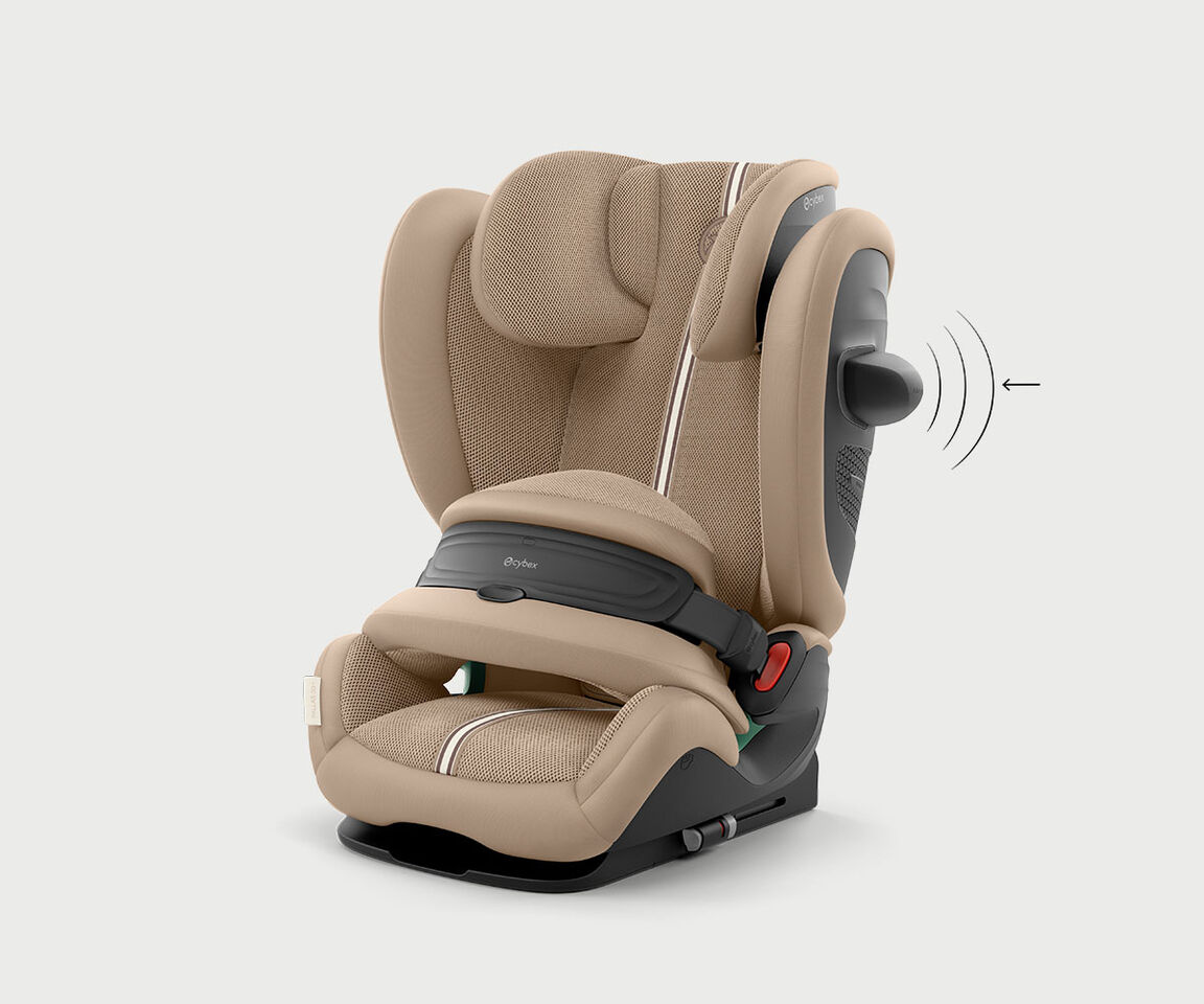 Pallas G3 growing car seat in beige fabric, featuring adjustable headrest and safety belt system