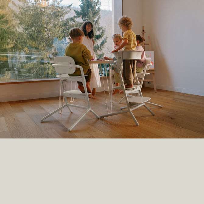 Five children sitting around a table, all sitting or standing on a Lemo 3-in-1 chair.