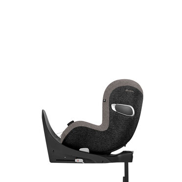 A side profile of a modern child car seat with grey fabric cover and black base.