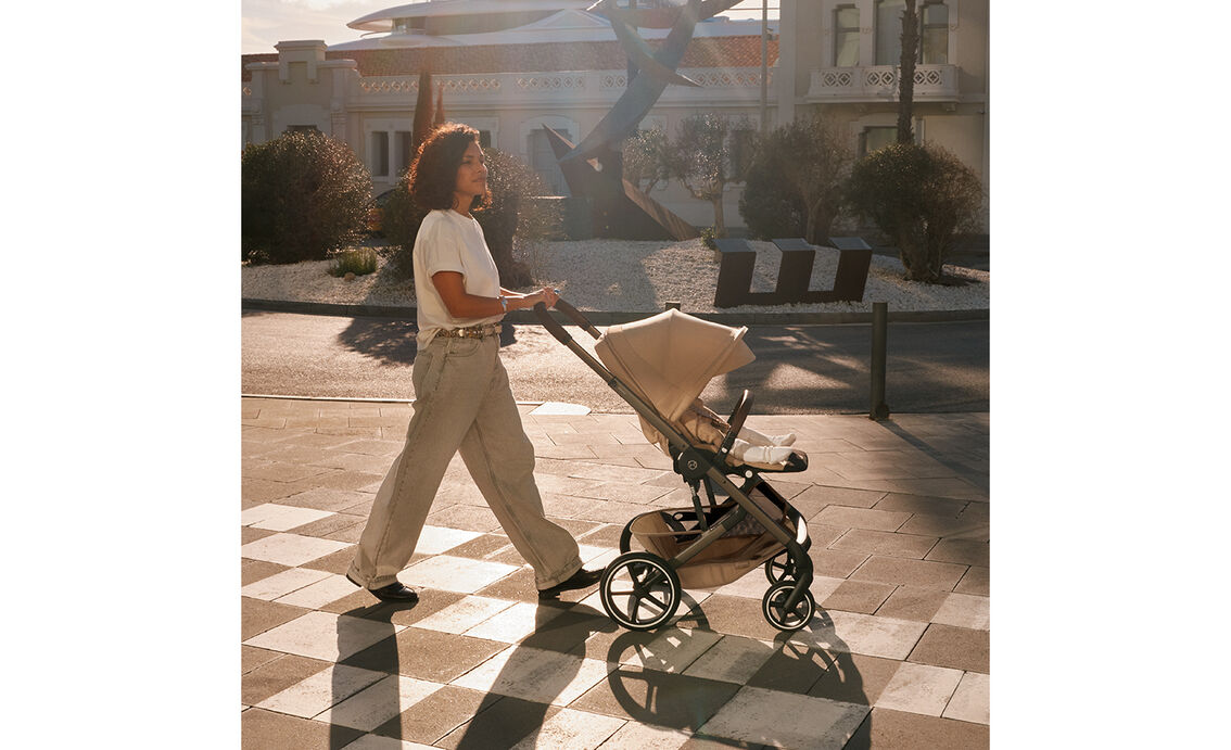 A mother strolling in the setting sun with her Balios S Lux stroller.
