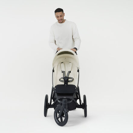 Product shot of a man pushing an Avi Spin stroller.