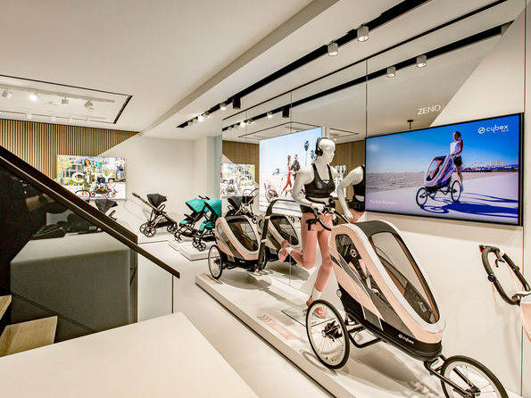 CYBEX Flagship Store Amsterdam showcasing a variety of pushchairs and a mannequin display.