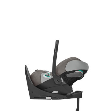 A grey infant car seat with a black base and carrying handle.