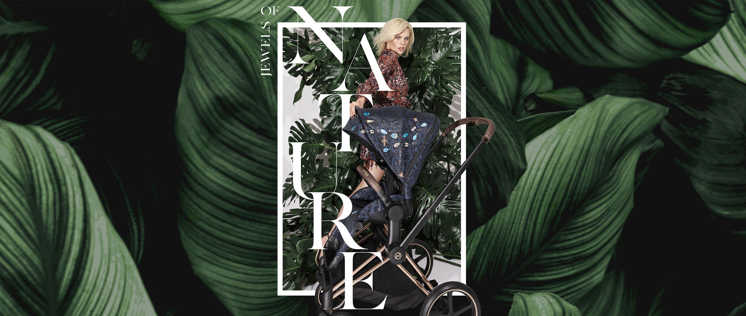 A woman in a patterned dress stands behind a stroller, surrounded by large green leaves. The text "Jewels of Nature" is overlaid on the image.