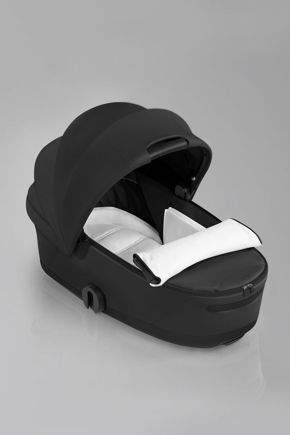 Product image of a Fold Lux Carry Cot and the ergonomic cushion it provides.