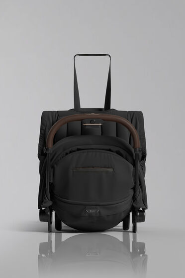 Close up of a folded up Coya with the strap where you could carry it highlighted.