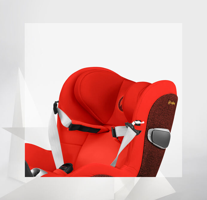 A red Sirona Z car seat with padded sides and a safety harness.
