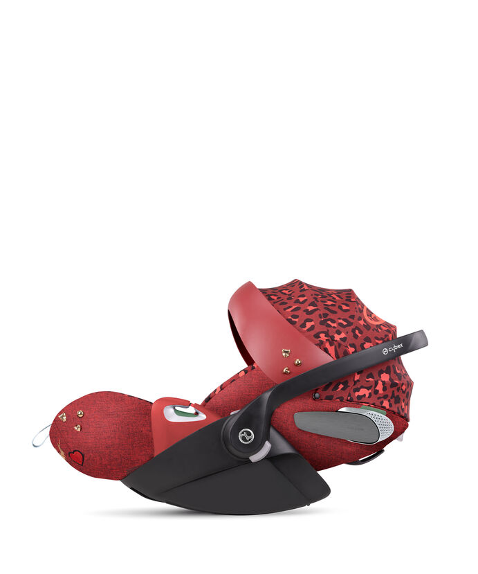 CYBEX Rockstar car seat in red with leopard print and heart details.