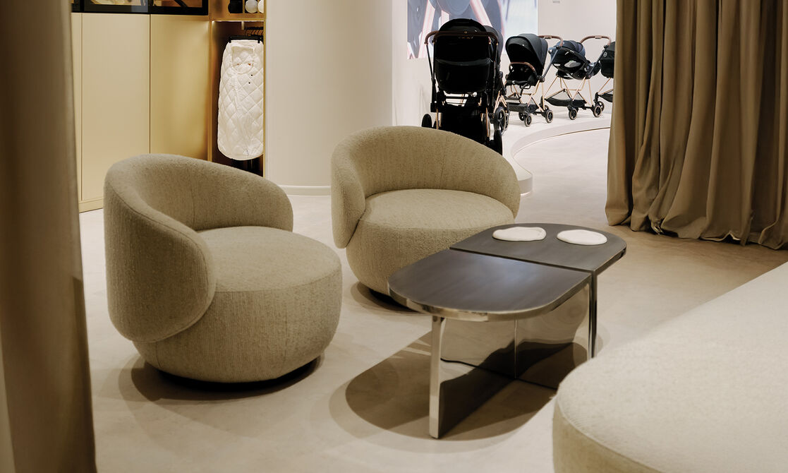 Two armchairs and a table inside the Flagship Store Berlin.