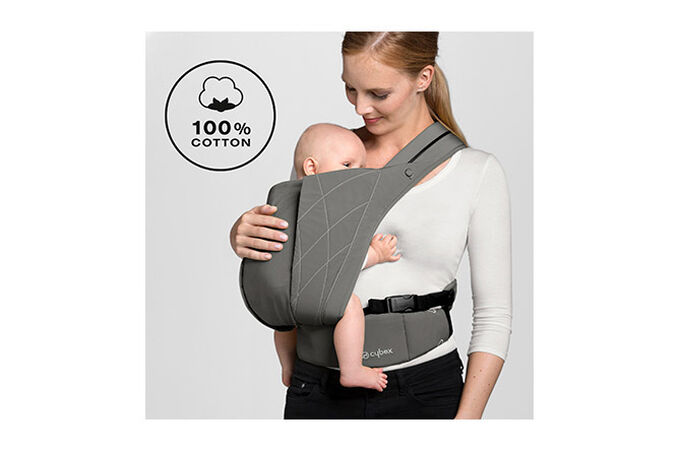 An image of the CYBEX Platinum YEMA.click Baby Carrier, highlighting the Wrap-like cotton fabric feature.