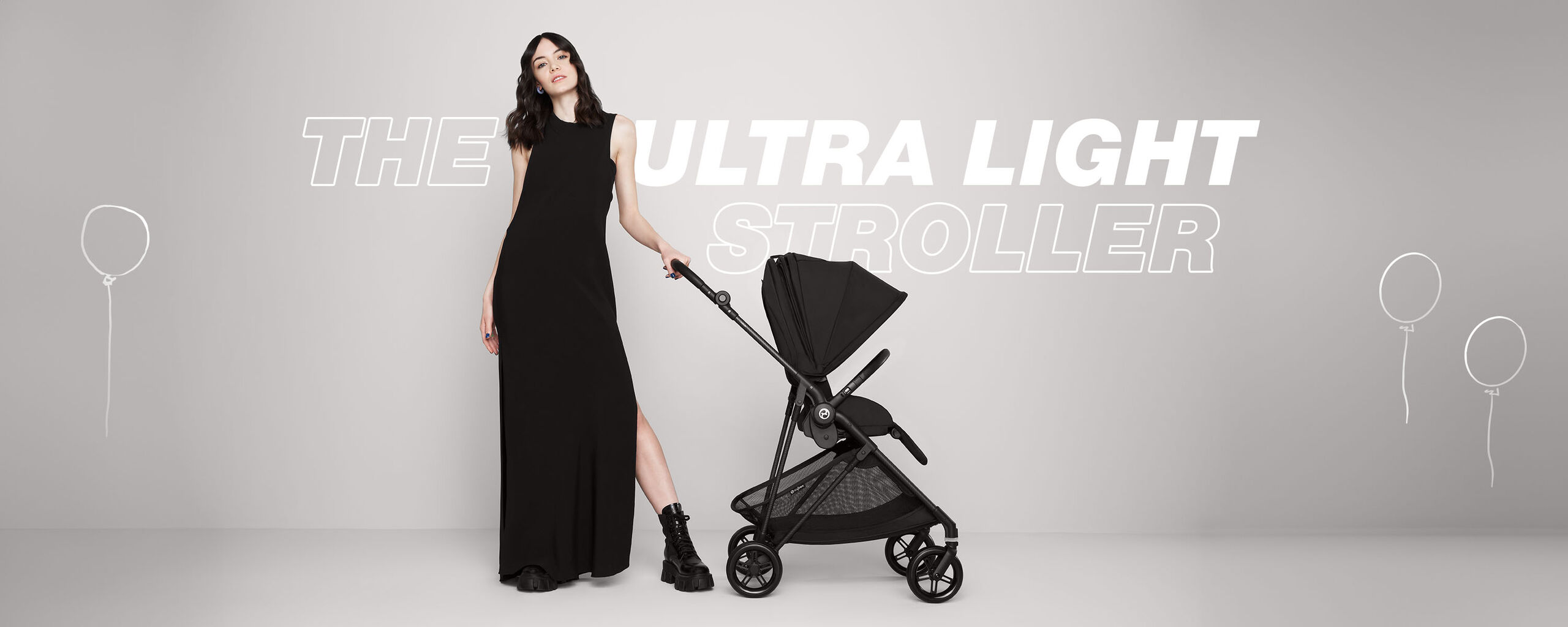 A fashionable woman in a black dress and boots pushes the CYBEX Melio Carbon, the lightest stroller in the United Kingdom, with an infant car seat, set against a neutral backdrop