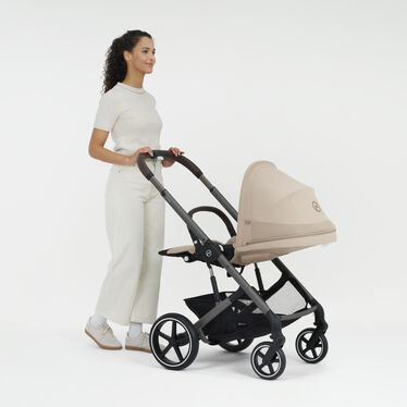 An image of the CYBEX Gold Balios S Lux Stroller, highlighting the Ergonomic Lie-flat Position feature.