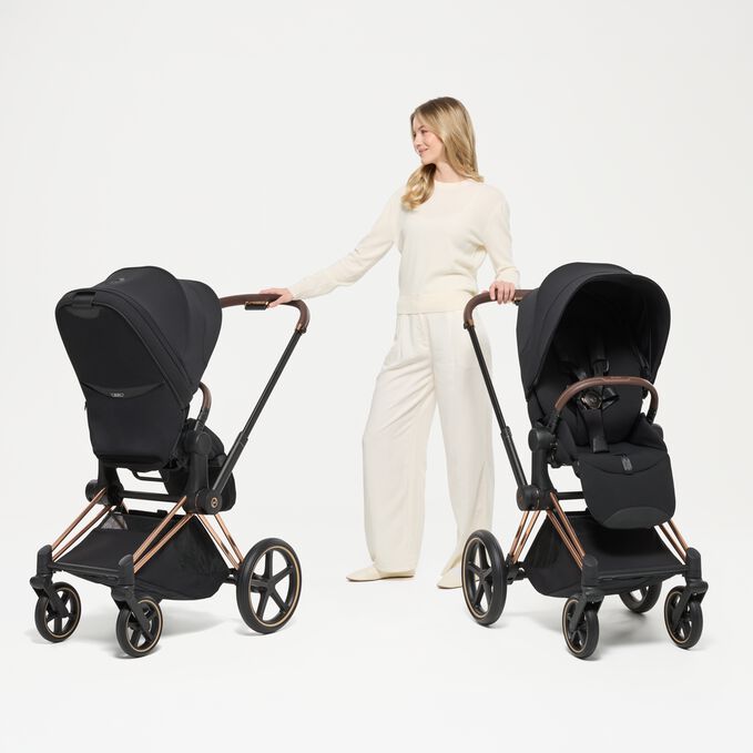 An image of the CYBEX Platinum Priam - Style Collection Stroller Travel Set, highlighting the Reversible Seat Unit feature.