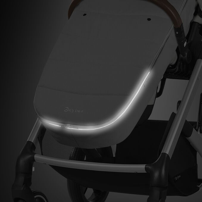 An image of the CYBEX Gold Gold Footmuff Accessories for Strollers, highlighting the Reflective Piping feature.