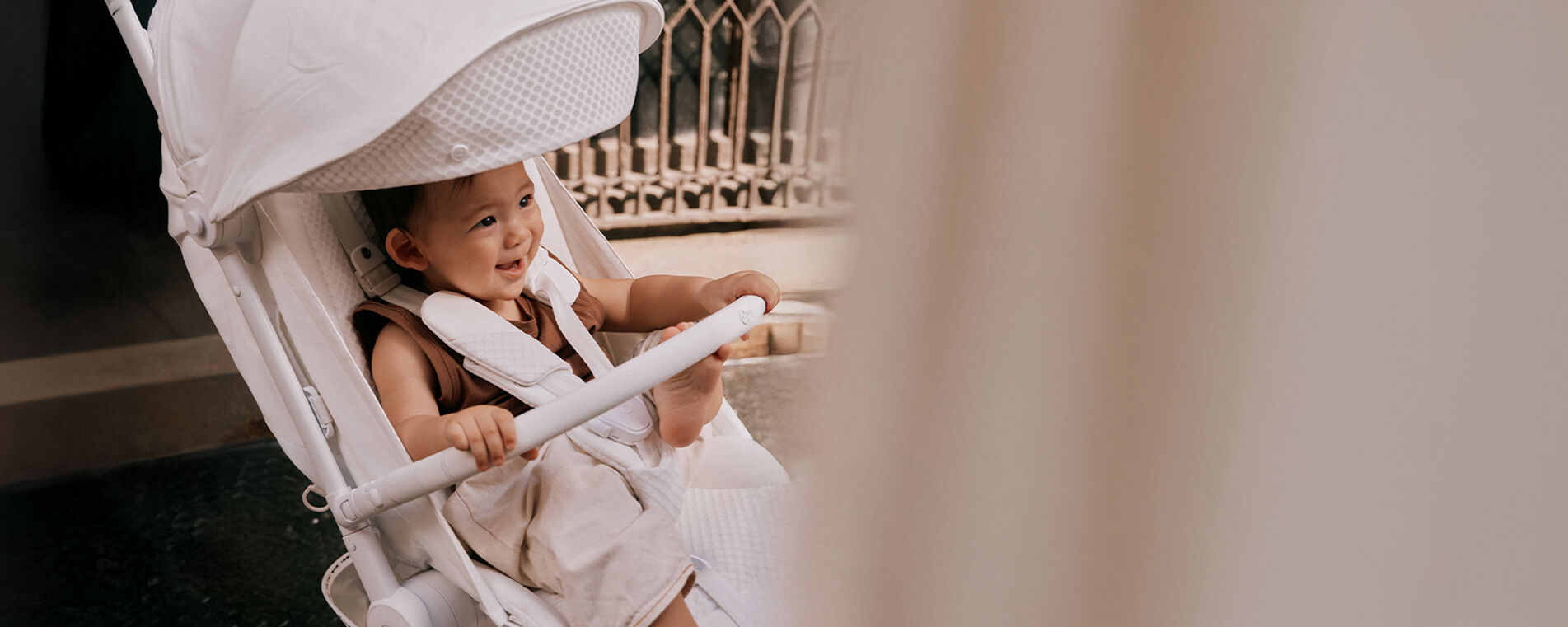 A baby sitting in a Coya Urban Mobility buggy. 