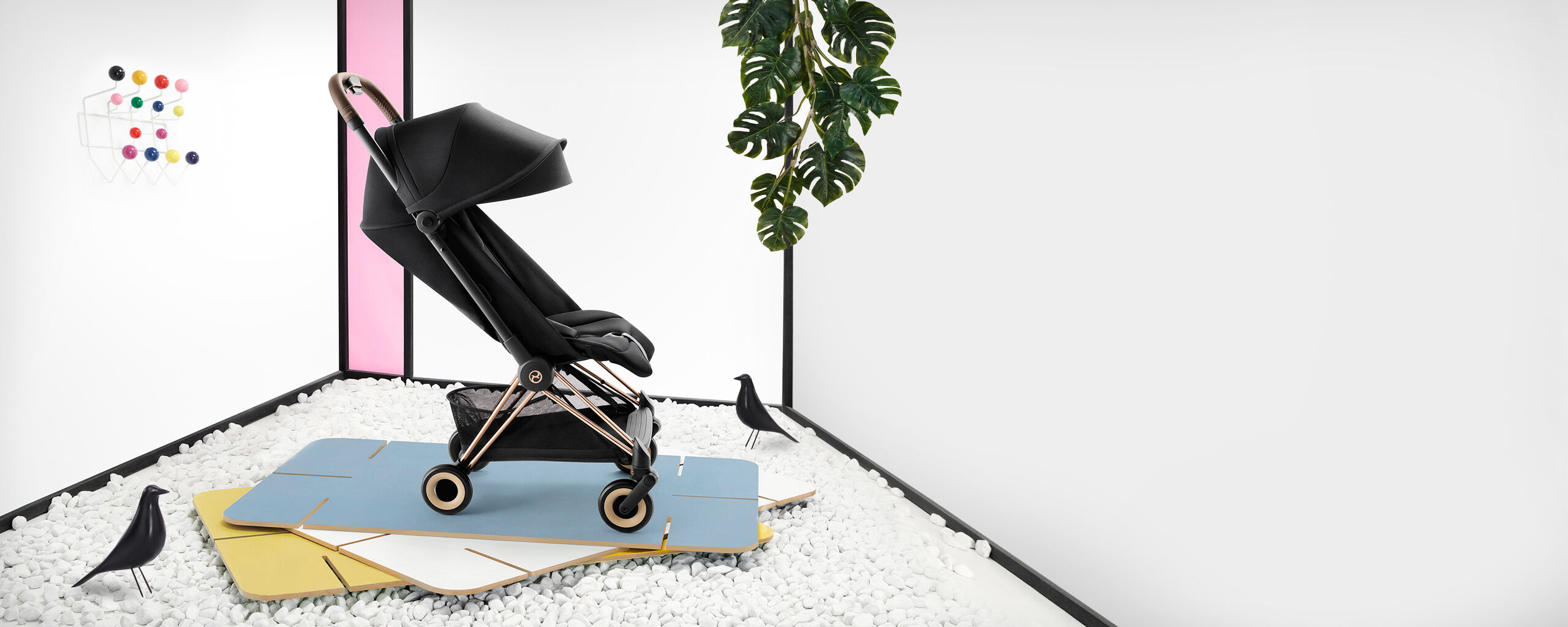 Coya compact travel stroller in a stylish room with decorations.