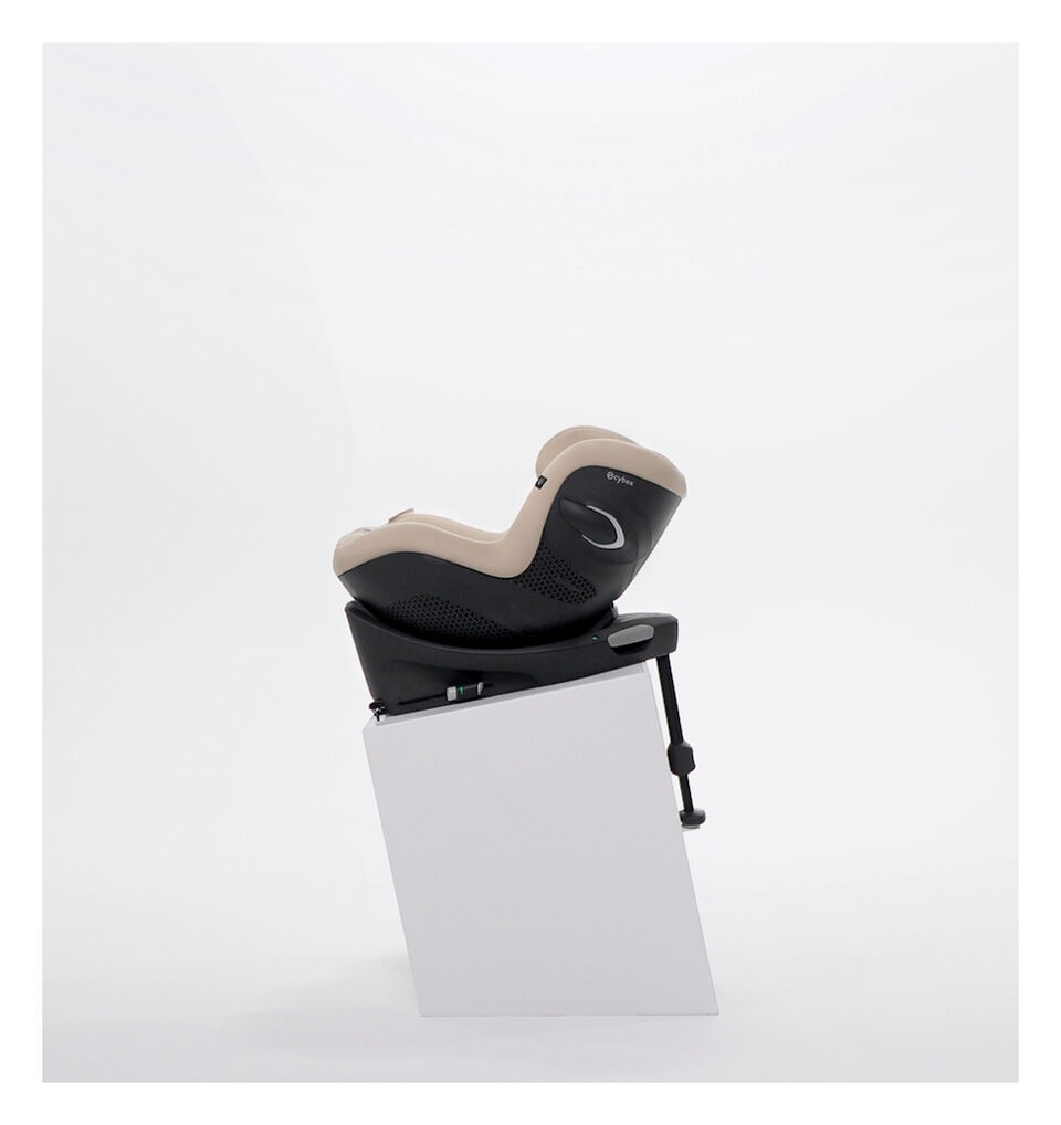 Side view of Sirona G i-Size in Almond Beige in a Base G, secured with a tether.