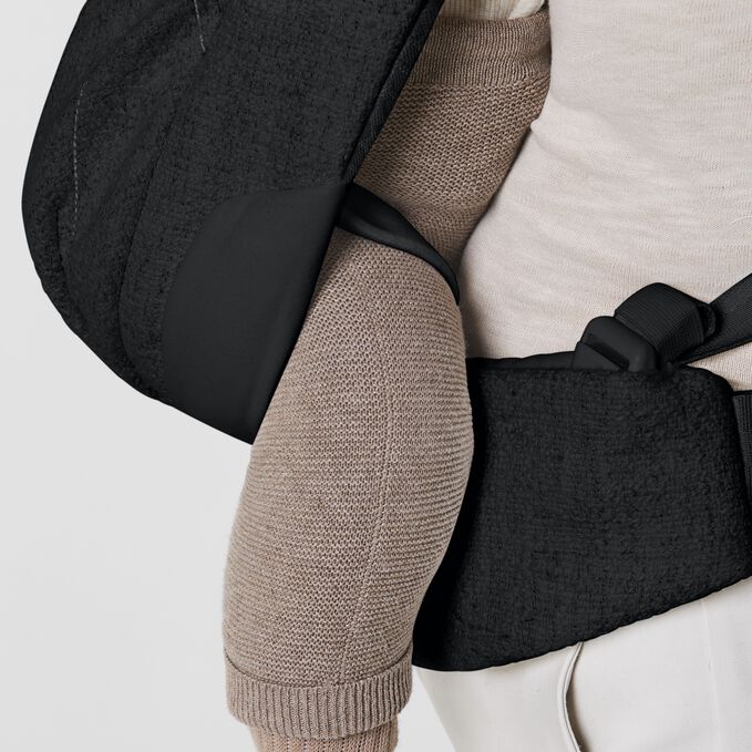 An image of the CYBEX Platinum Coya Carrier Bouclé Baby Carrier, highlighting the Leg Securing Straps feature.