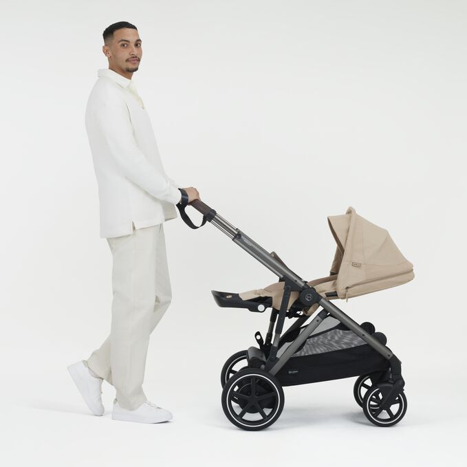An image of the CYBEX Gold e-Gazelle S Sibling Stroller, highlighting the Ergonomic Lie-flat Position feature.